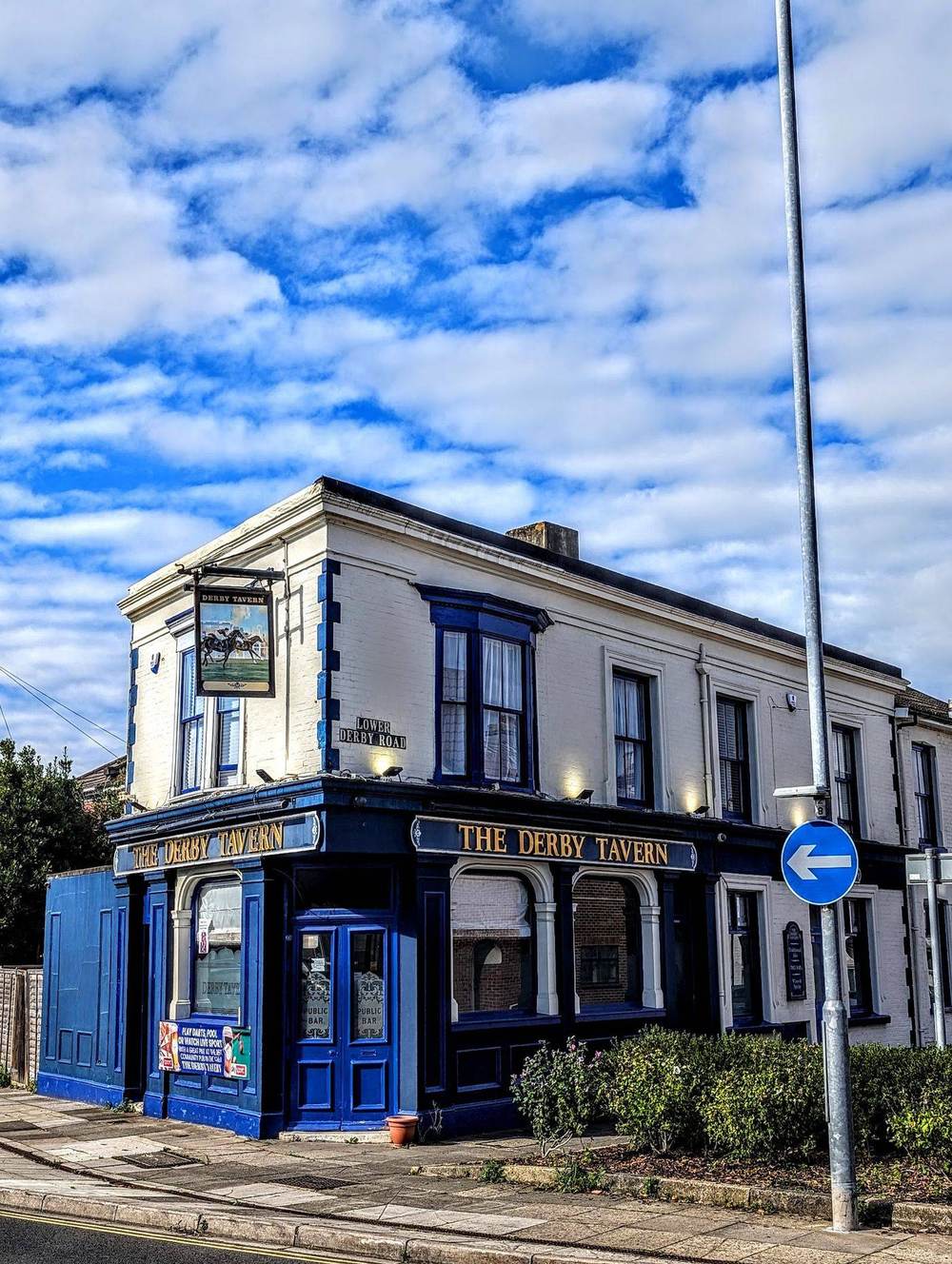 The Derby Tavern's navy-and-cream frontage with the hanging Derby horse sign